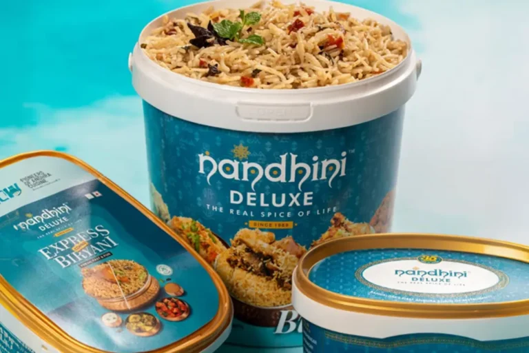 Nandhini Deluxe branded biryani tubs and an Express Biryani pack, showing the teal-and-gold packaging with the Nandhini logo.
