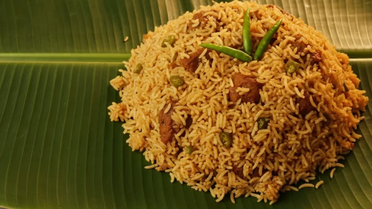 Nellore biryani served on a banana leaf with green chillies